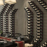 Wine bottles arranged on a wall-mounted rack in a modern dining room.